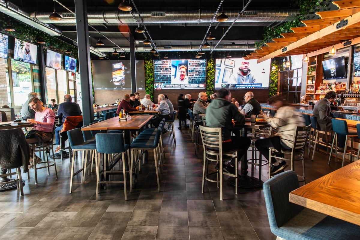 On the Kirb features a wall of fake greenery; a long, blue-marble bar, tables that seat 2-10, and multiple TVs of various sizes on every wall.