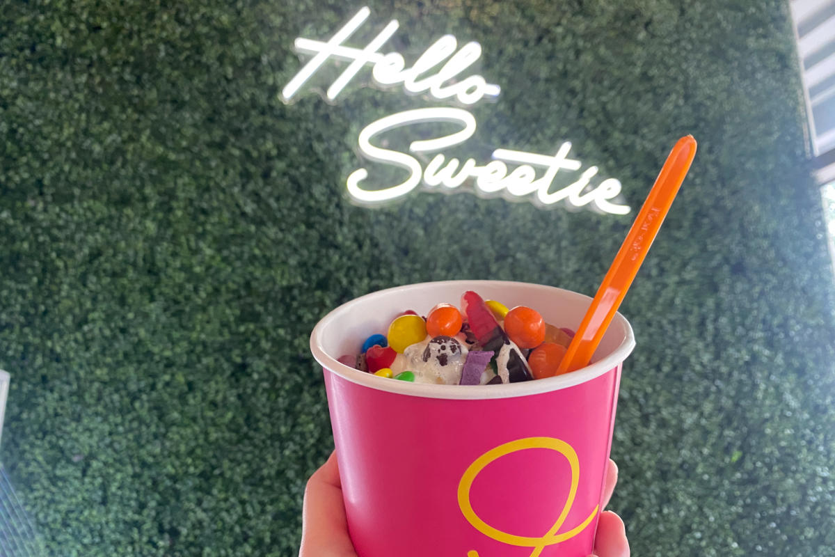 Cup of frozen yogurt with candies at Sweet Frozen Bar
