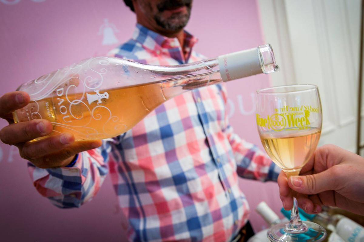 Person pouring wine at Rose Way A Sweet Soiree in The Woodlands, Texas