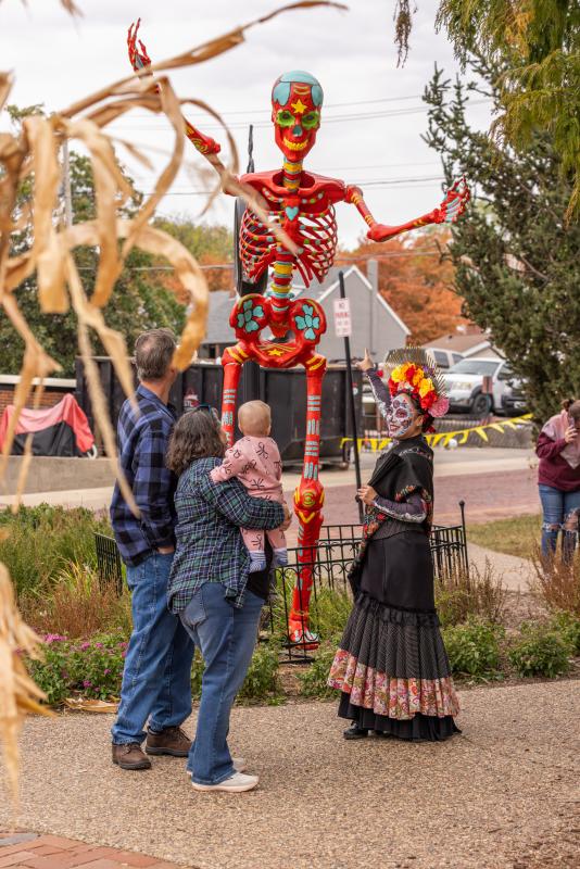 La Catrina, a character from Legends & Lanterns, interacts with guests on Historic Main Street in St. Charles, MO.