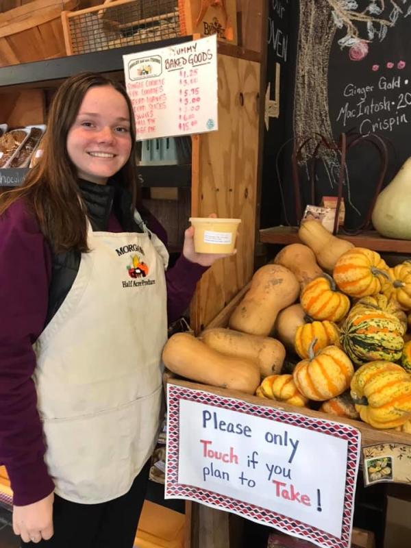 Employee showing off produce at Morgan's Half Acre Produce