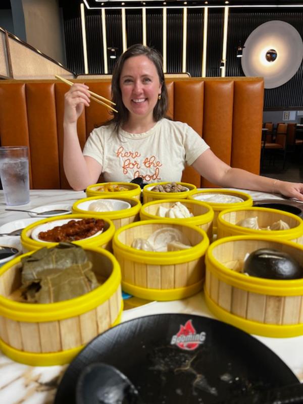 Woman at a table full of yellow hot pot dishes