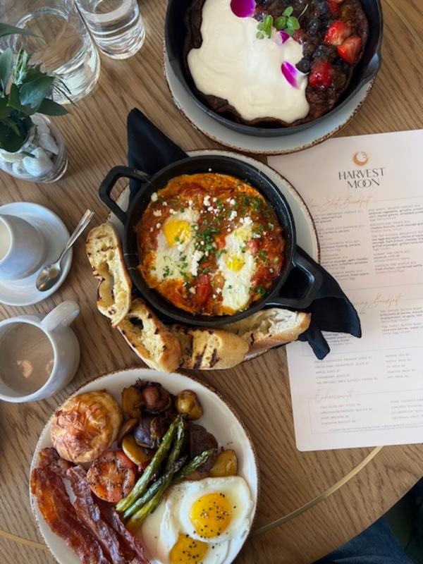 Table with three dishes of food and a menu
