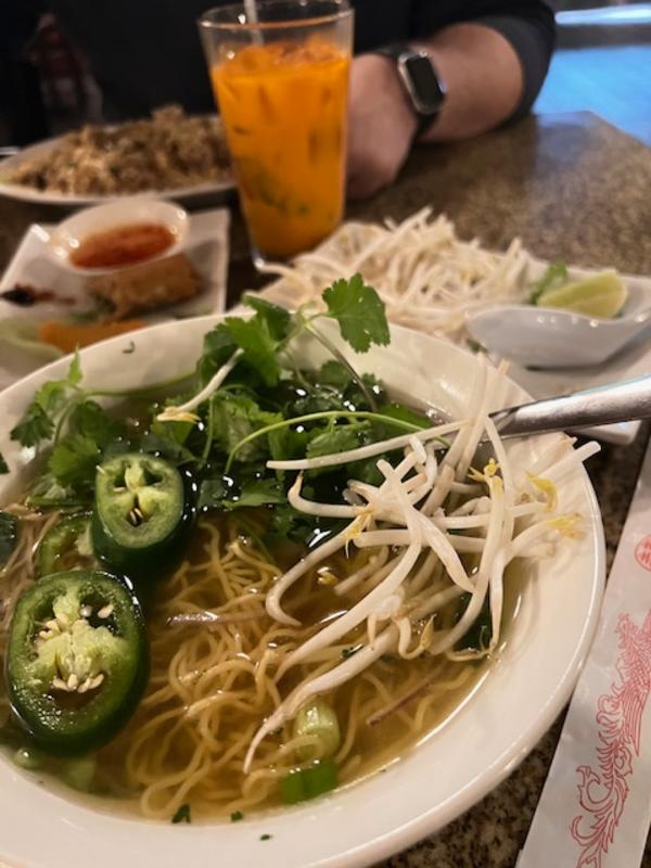 Bowl of noodles and dishes on a table at Viet Huong