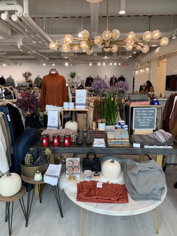 A display of accessories in front of the clothing racks at Leela & Lavender 