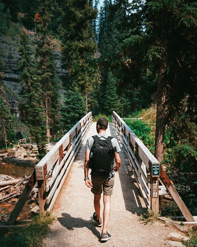 Photo by user hikeology, caption reads “it’s impossible to walk in the woods and be in a bad mood at the same time” - not sure where that saying originated, but i know it’s 💯 percent true. this trip was not perfect by any means, from flight delays, to car trouble, to wildfires and thunderstorms 😑 i’ll admit, there were moments when we thought this trip was cursed. but when life gives you low visibility and skies raining ash - hike to a waterfall 🤷🏼‍♀️ amiright? the beautiful hike to ousel falls was a wonderful distraction to all our travel woes and a great reminder to stop worrying and live in the moment ✨
.
.
if you happen to find yourself in big sky this is a great 1.6 mile hike with a big reward for fairly little effort. if you head out on the trail, pack some snacks (and remember to pack out your trash!) - the trail is very well maintained and sprinkled with picnic tables along the way.
.
.
.
#hikeology #amateuradventurer #hike #hiking #hiker #hikelife #hikemontana #hikebigsky #bigsky #bigskyhikes #montanahikes #lonemountain #bigskymeadow #ouselfalls #ouselfallspark #getoutside #exploremontana #roadtrip #travel #waterfallhike #gallatinriver #gallatingateway #sonyalpha #sonya7ii #sonyalpha7ii