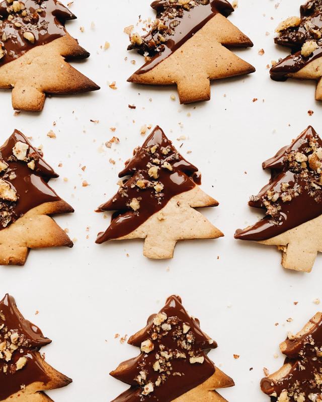 Christmas cookies in the shape of Christmas trees with chocolate on them