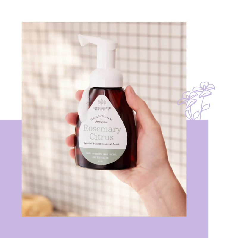 Hand holding bottle of Rosemary Citrus foaming hand soap