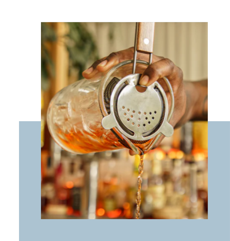 Beverage being poured through cup strainer