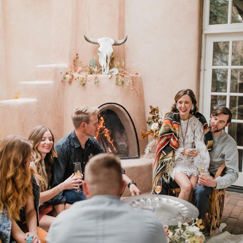 A group of people converse at Los Poblanos Historic Inn and Farm