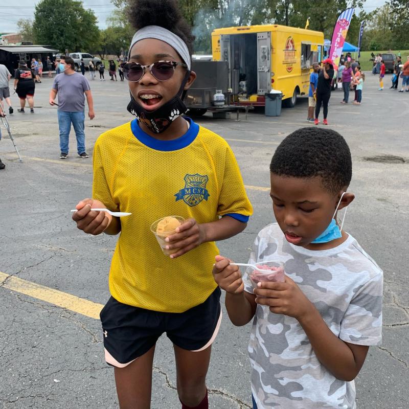 kids with sno cones near a food truck