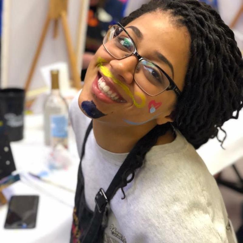 A girl with paint on her face at All Fired Up! paint your own pottery studio in West Lafayette