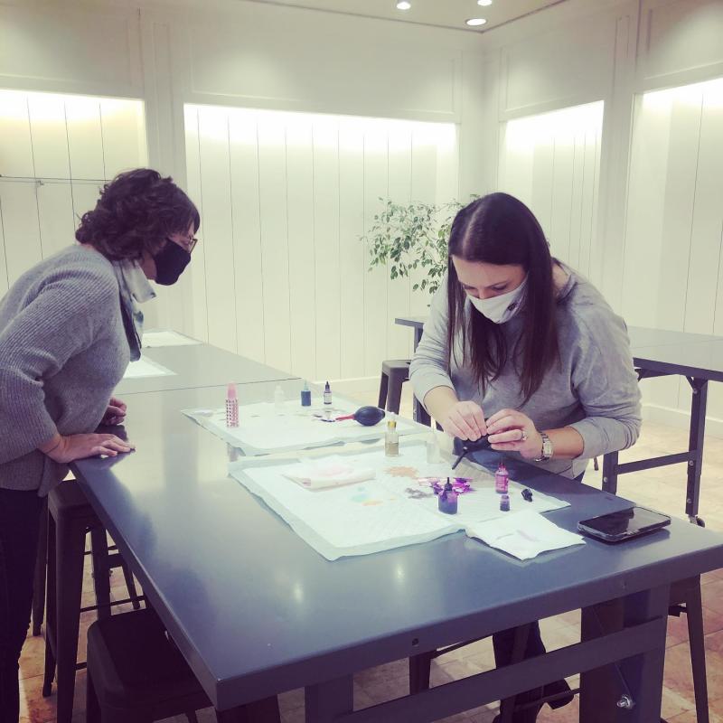 Two women at Fox Run craft event involving ink 