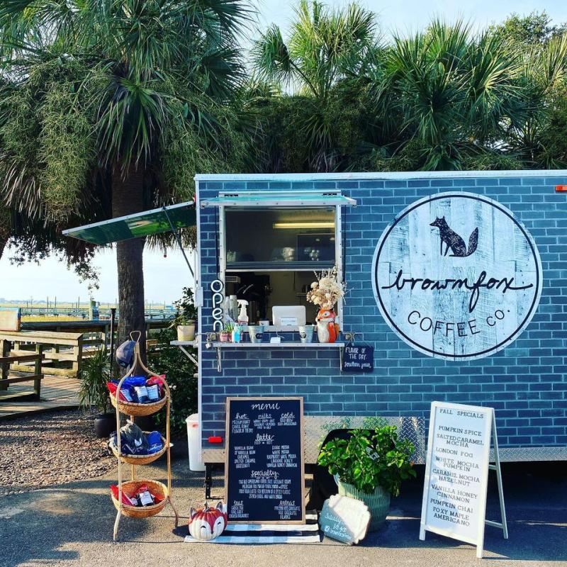 Small food trailer with a facade painted to look like blue bricks and a logo that says Brown Fox Coffee Box, Murrells Inlet, SC