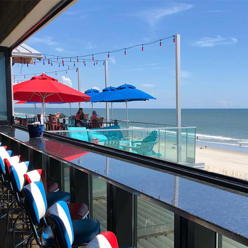 Tin Roof outdoor seating with view of ocean