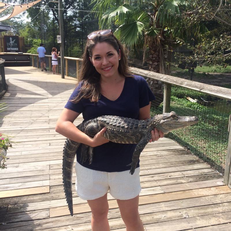 Nora holds an alligator at Alligator Adventures