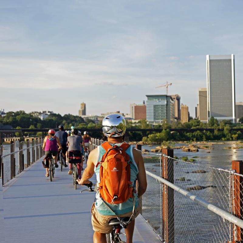 People Biking Across The T. Tyler Potterfield Bridge In Richmond, VA