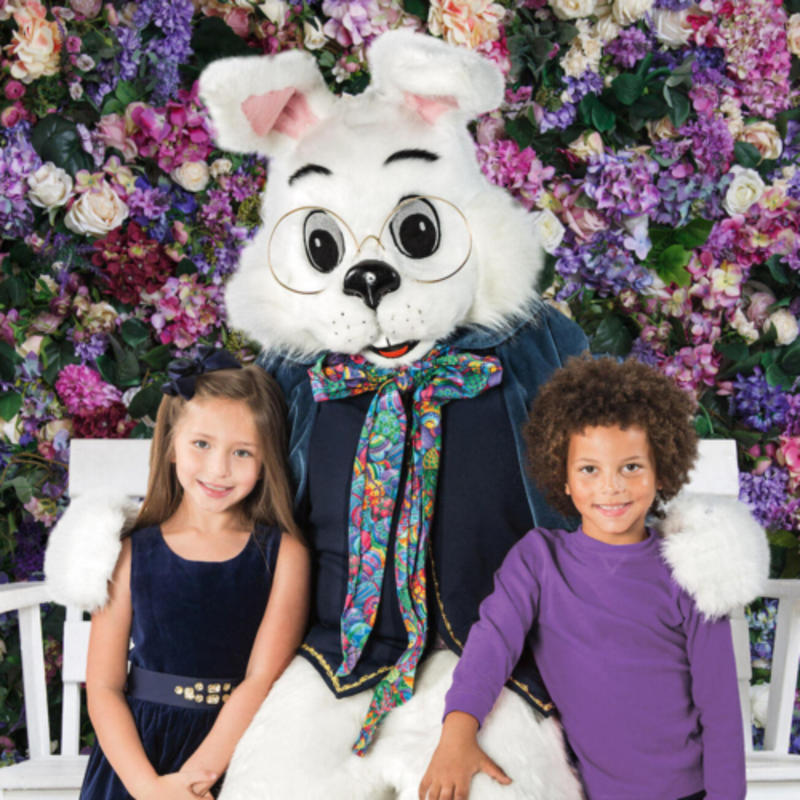 Two children taking a photo with Easter Bunny