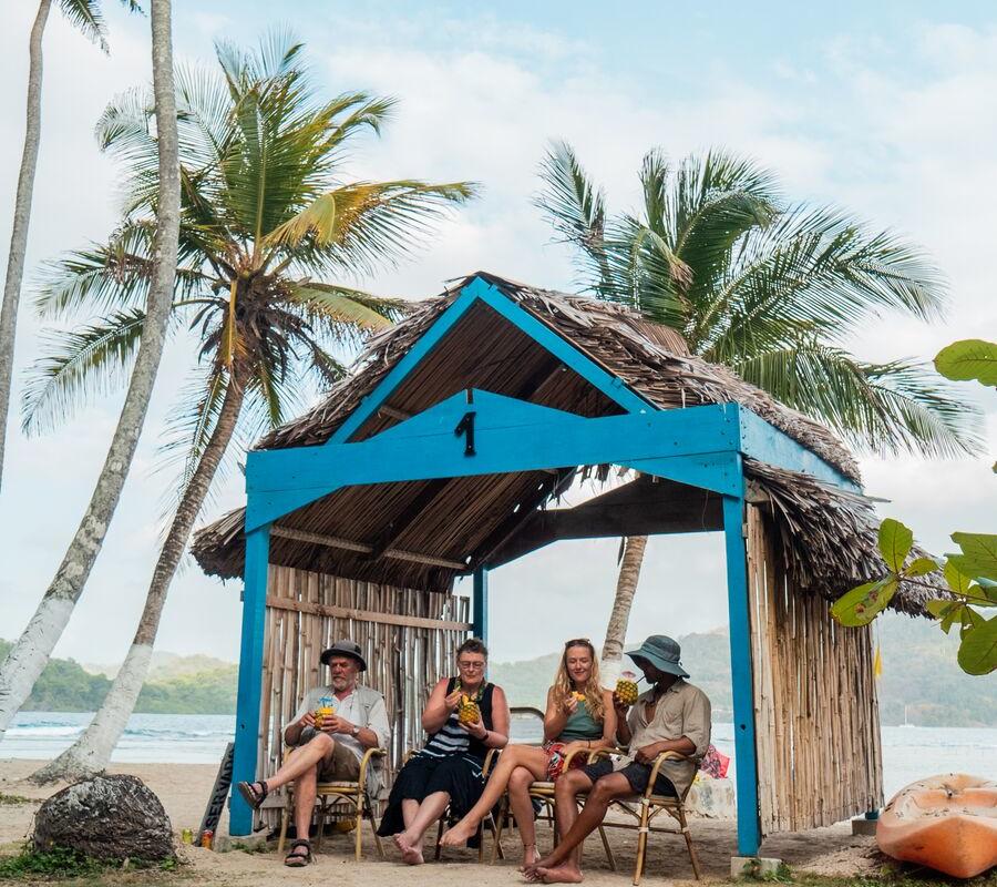Several individuals, completely at ease, enjoying each other's company in the cozy wooden house.