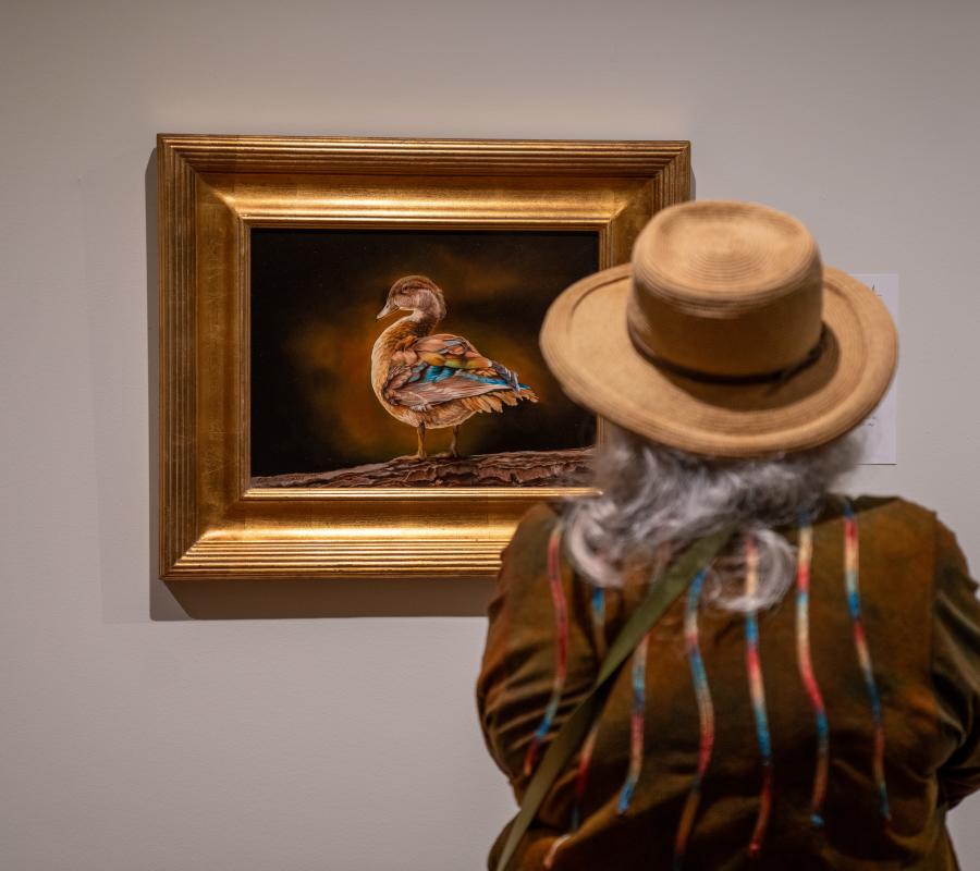 Woman looking at painting at Leigh Yawkey