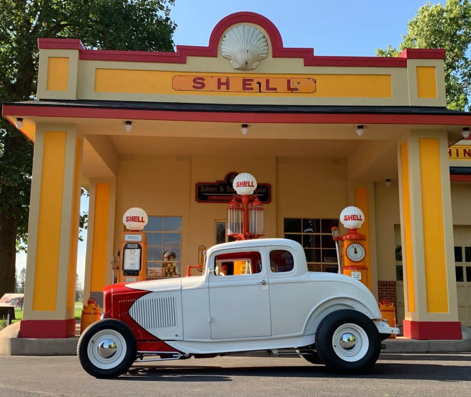 Classic car in front of an old gas station