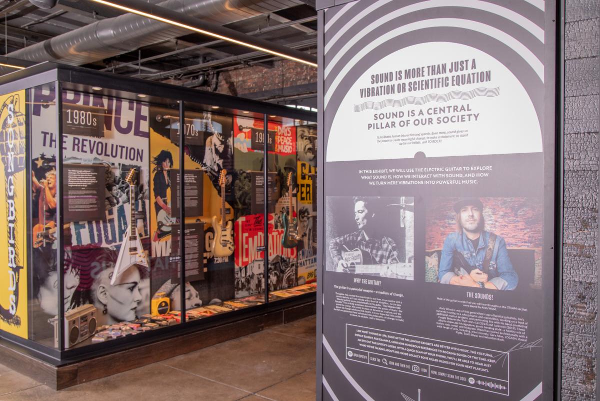 Songbirds Museum Interior photo shows installation and board with info about music being "more than just vibrations"