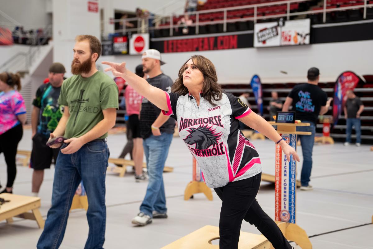 lady and man playing cornhole