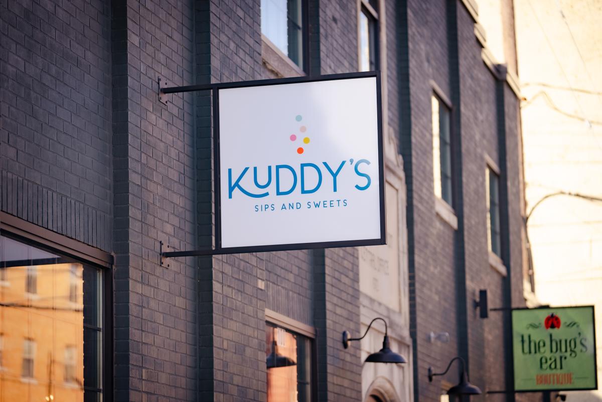 kuddy's sips and sweets sign on exterior of the assembly building