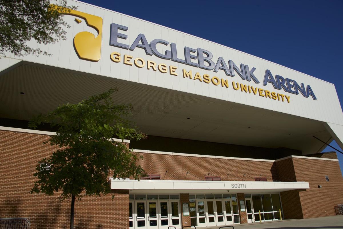 EagleBank Arena at George Mason University features a large, modern facade with prominent signage. The entrance is framed by greenery.