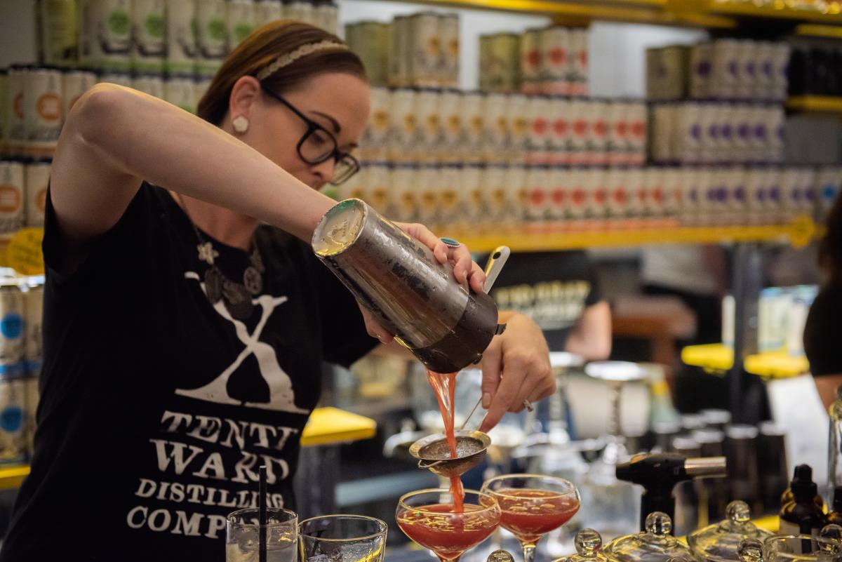 A female bartender making a drink at Tenth Ward Cocktail Lab