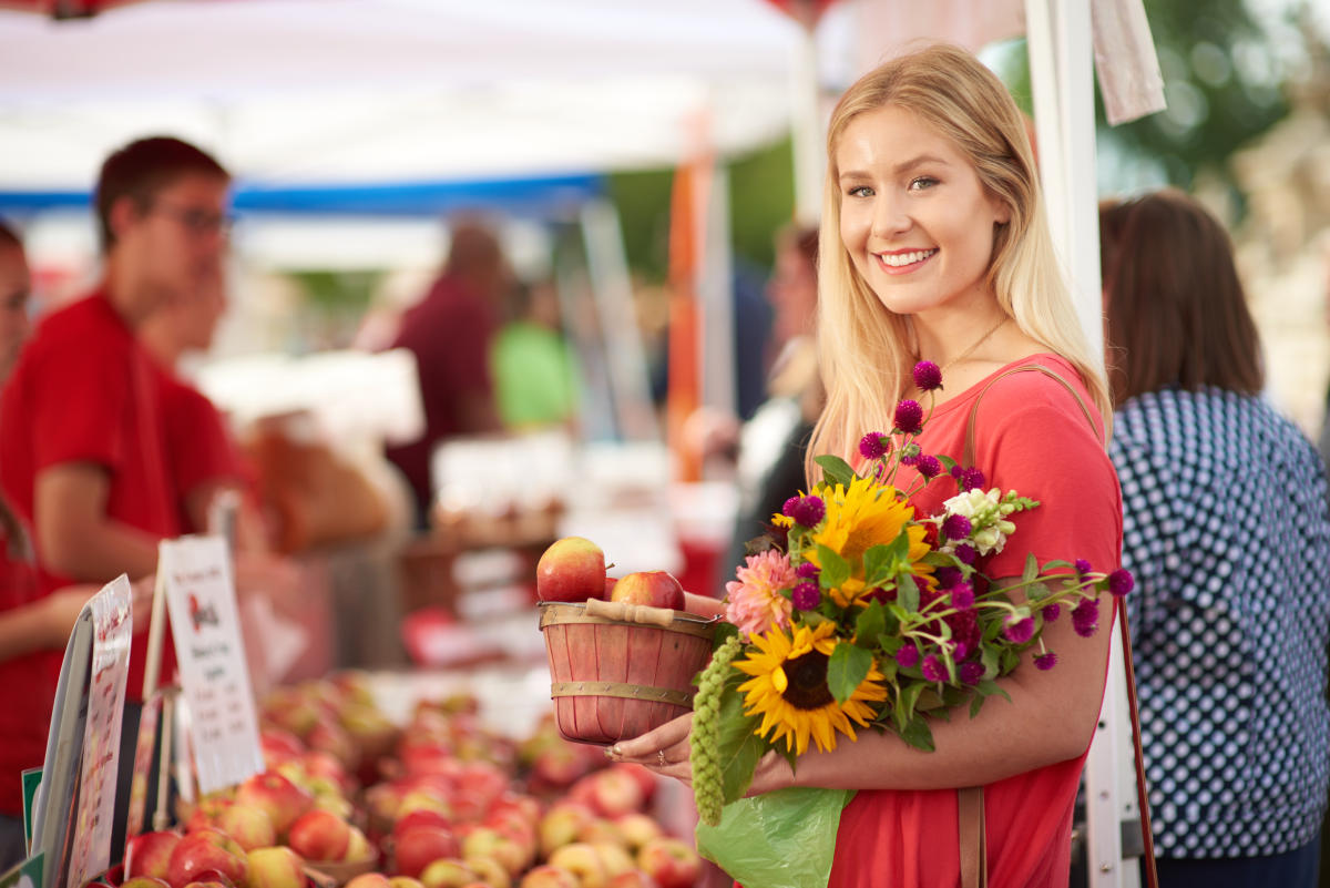 Person at farmers market with flowers