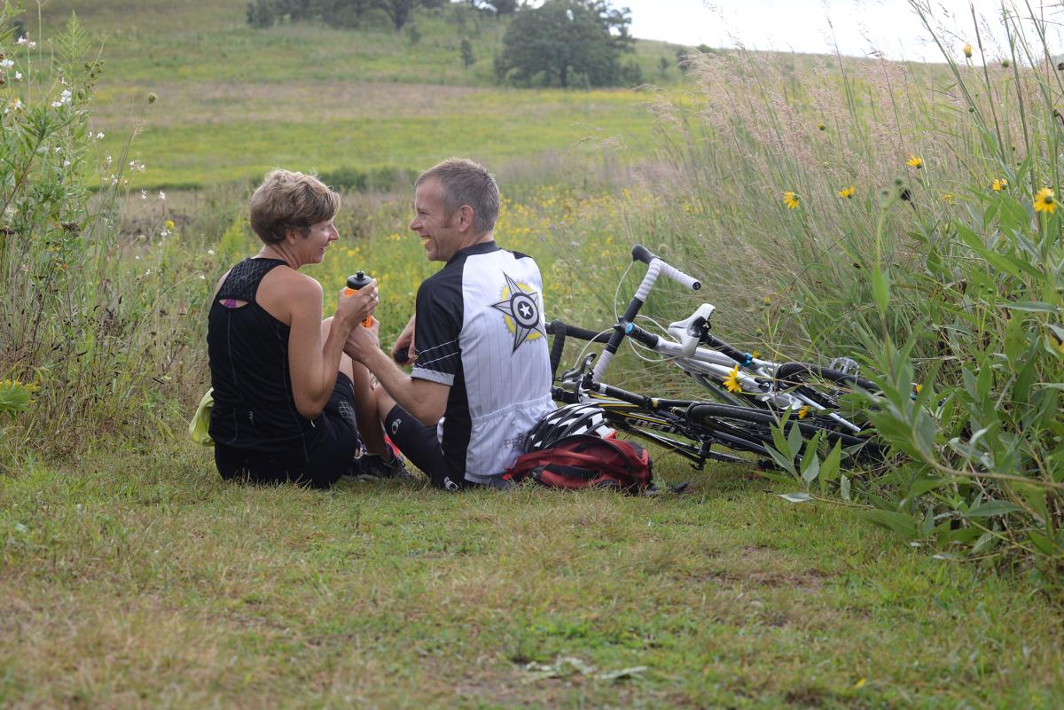 A couple taking a break from biking to have a picnic