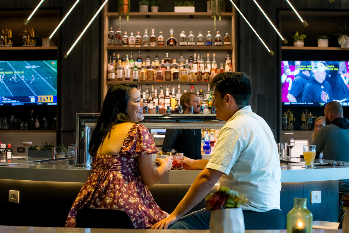 couple sitting at a bar enjoying some drinks