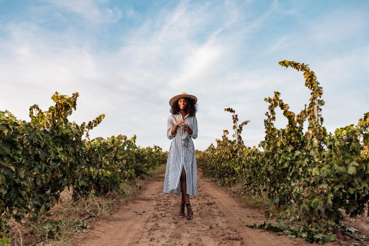 Woman Walking in Fall Vineyard