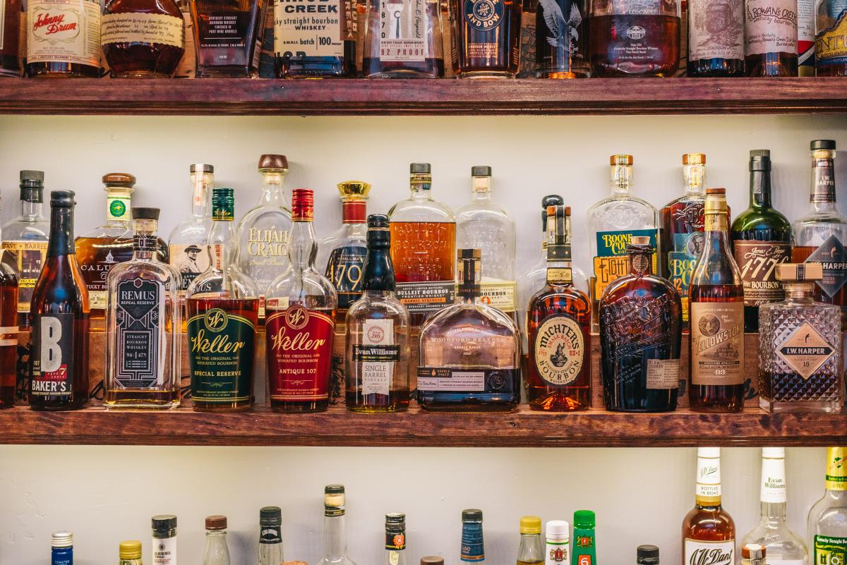 bourbon bottles on bar shelf