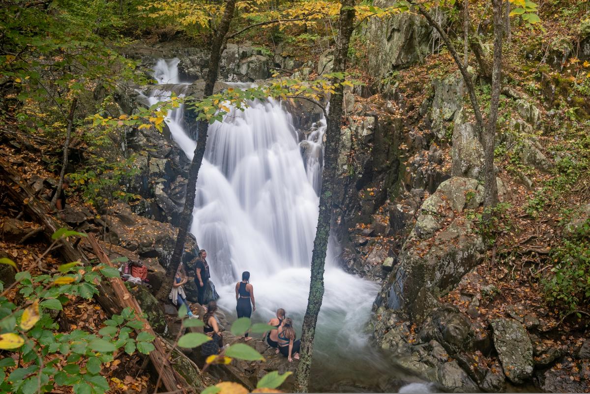 Waterfall at Rose River Falls with autumn foliage and visitors enjoying the scenery