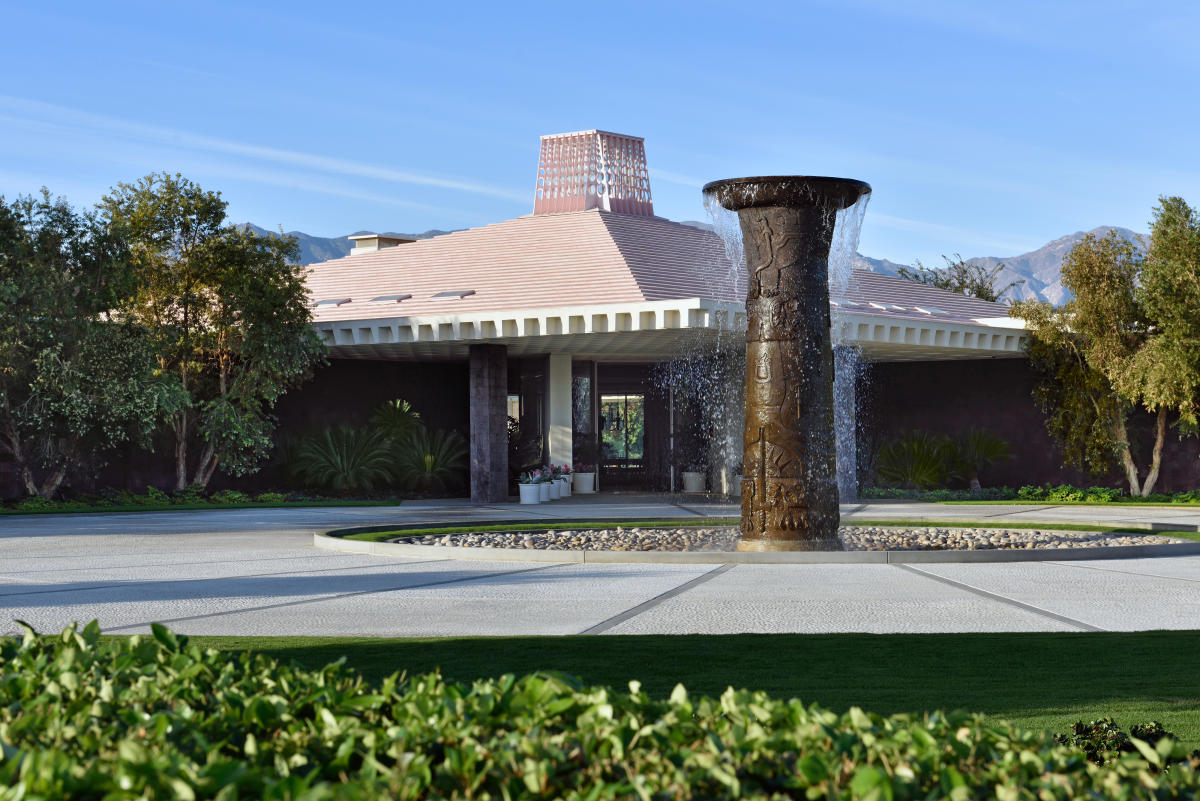 The exterior of the main house at Sunnylands with a bronze 20 foot tall columnal fountain in the front.