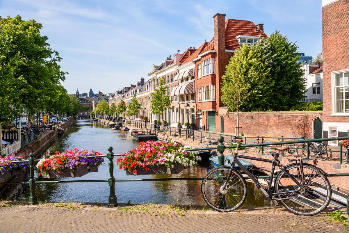 Traditional brick houses along a canal on a sunny summer day in Netherlands