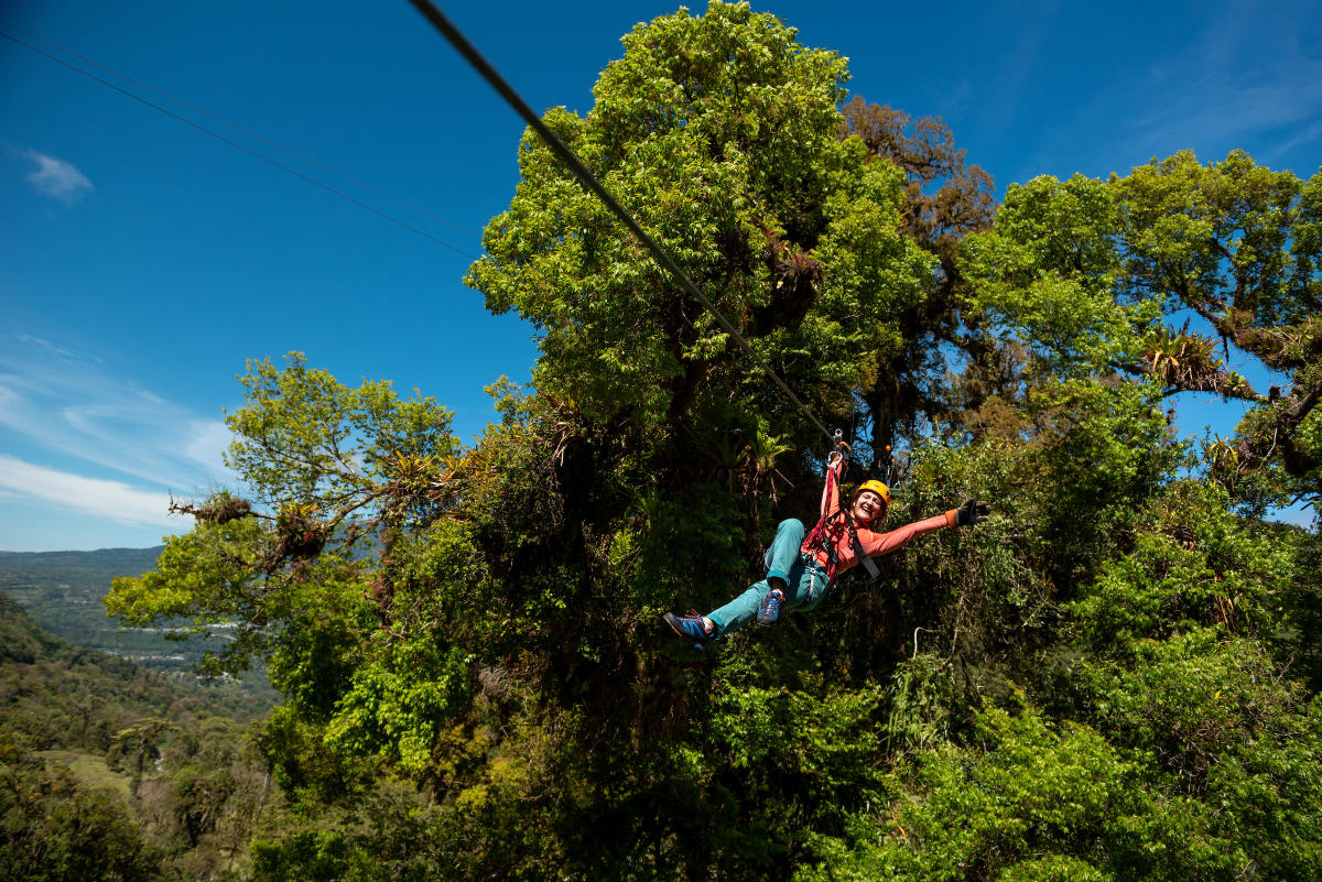 Woman zip lining surrounded by cloud forest at Boquete