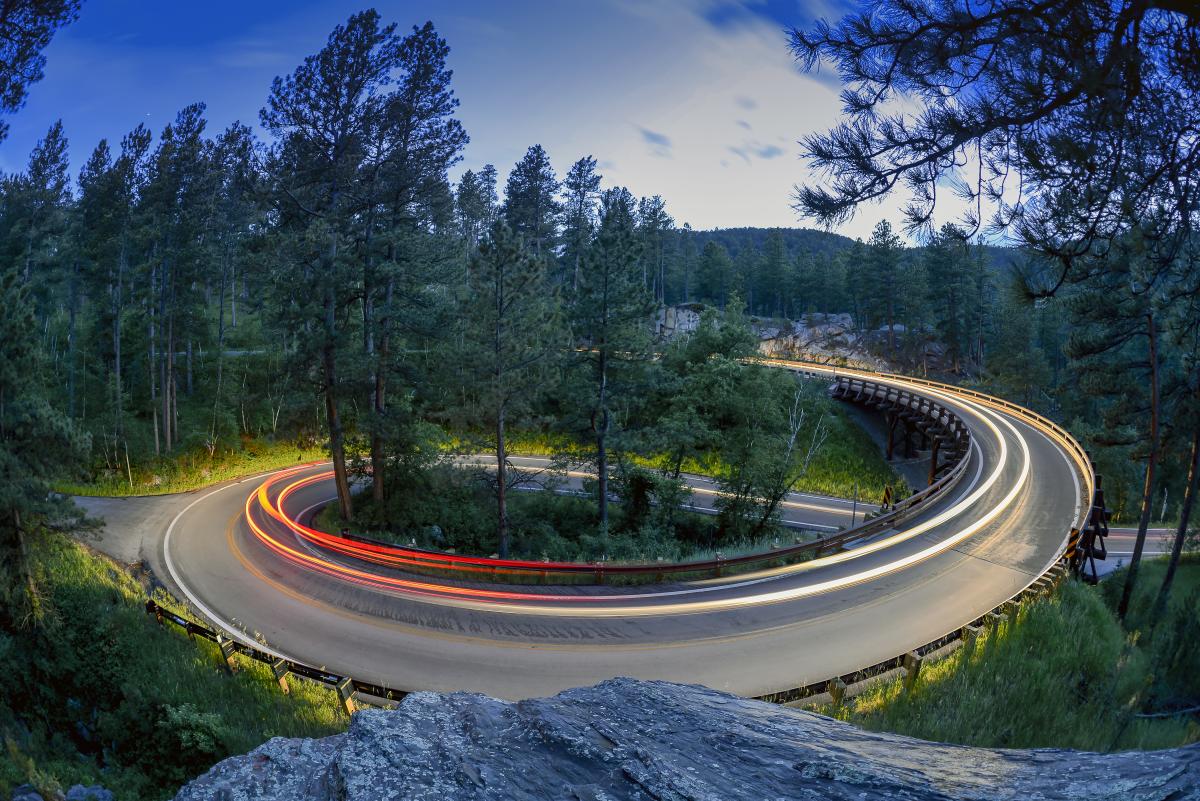 timelapse of car headlights looping around the pigtail curve of peter norbeck scenic byway