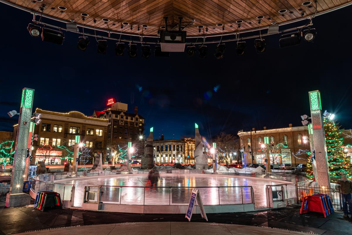 Ice skating rink at night in Main Street Square in downtown rapid city surrounded by lights and historic buildings