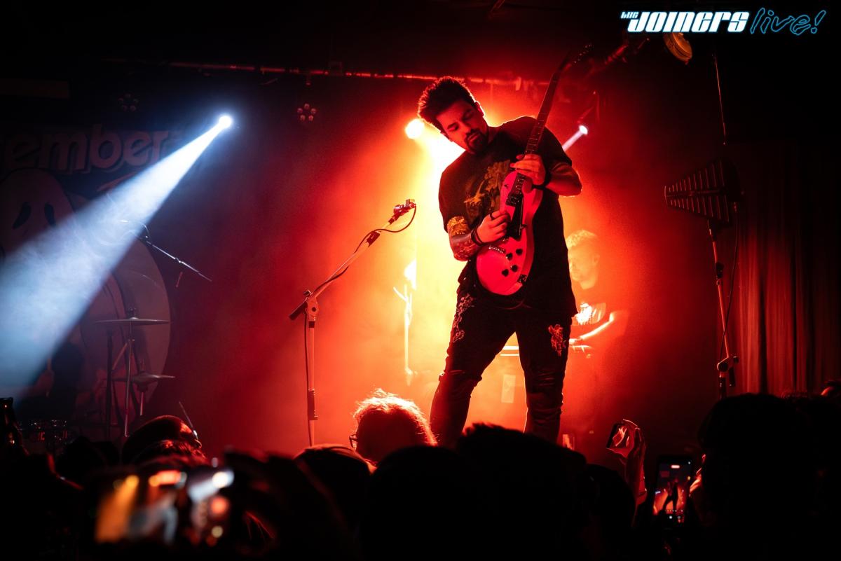 Lead guitarist of As December Falls playing guitar on stag at The Joiners