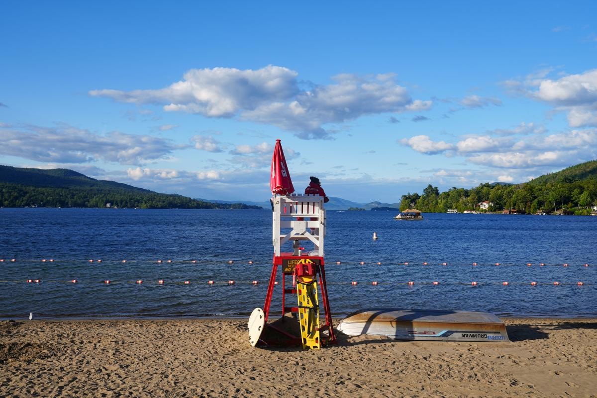Lifeguard chair on the beach facing Lake George and Adirondack Mountains