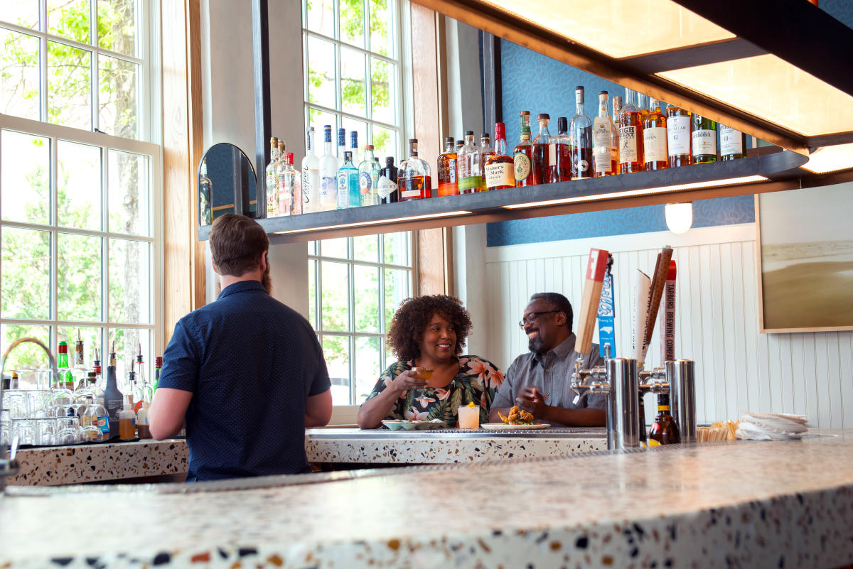 Couple dining at the bar inside Seabird restaurant