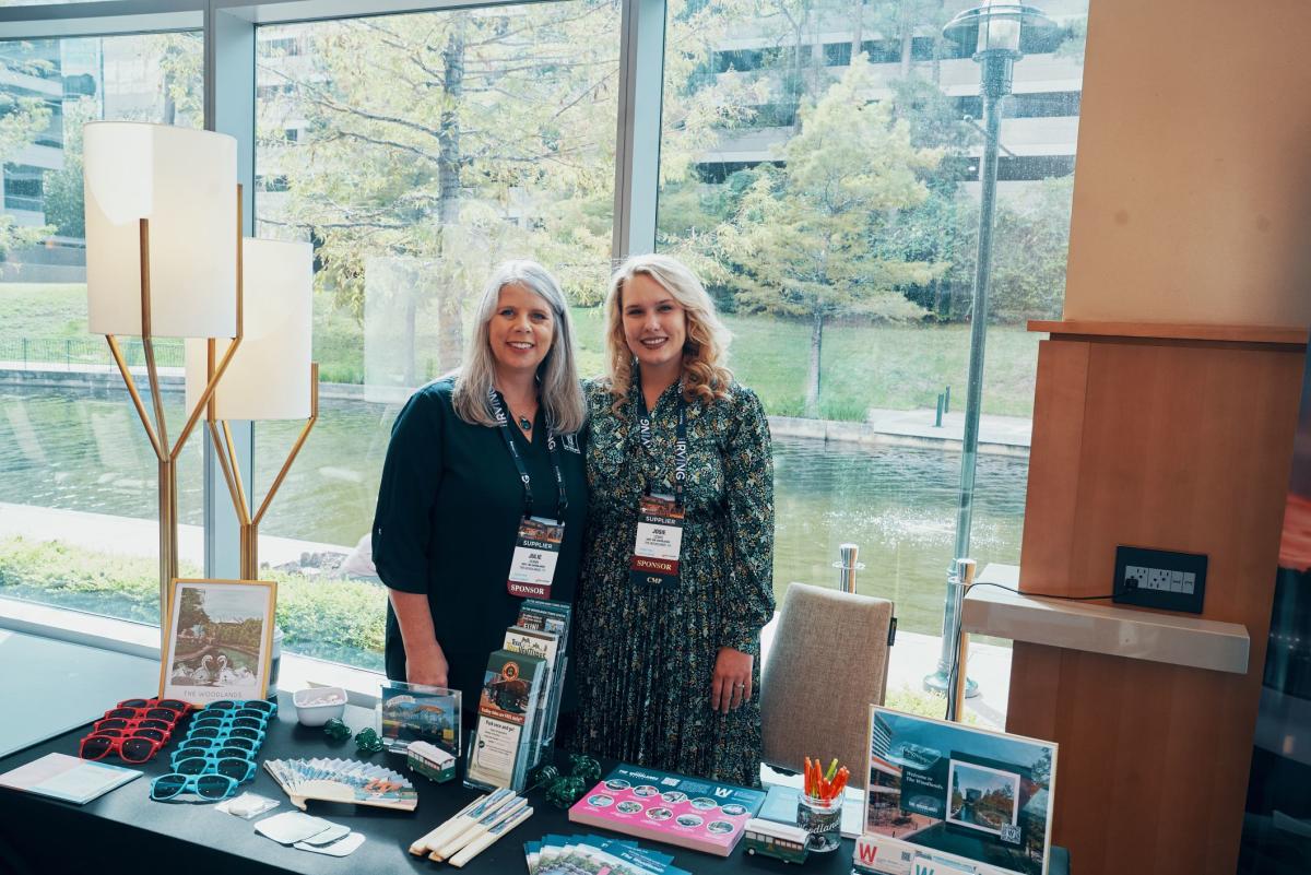 Julie Quinn and Josie Lewis standing at reception desk at Connect Texas in The Woodlands, Texas