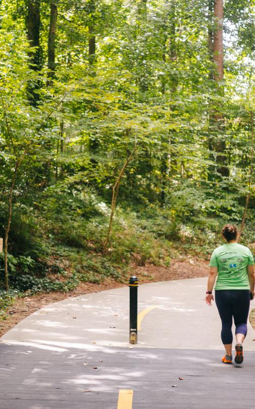A person walking on the trails at Brook Run Park