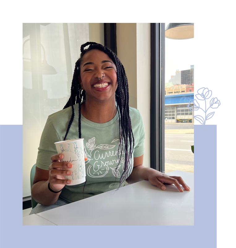Woman smiling with coffee cup at Freedom a la Cart