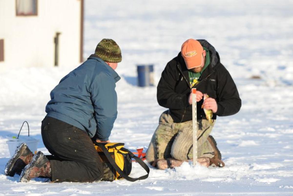 Two men ice fishing on Lake Altoona