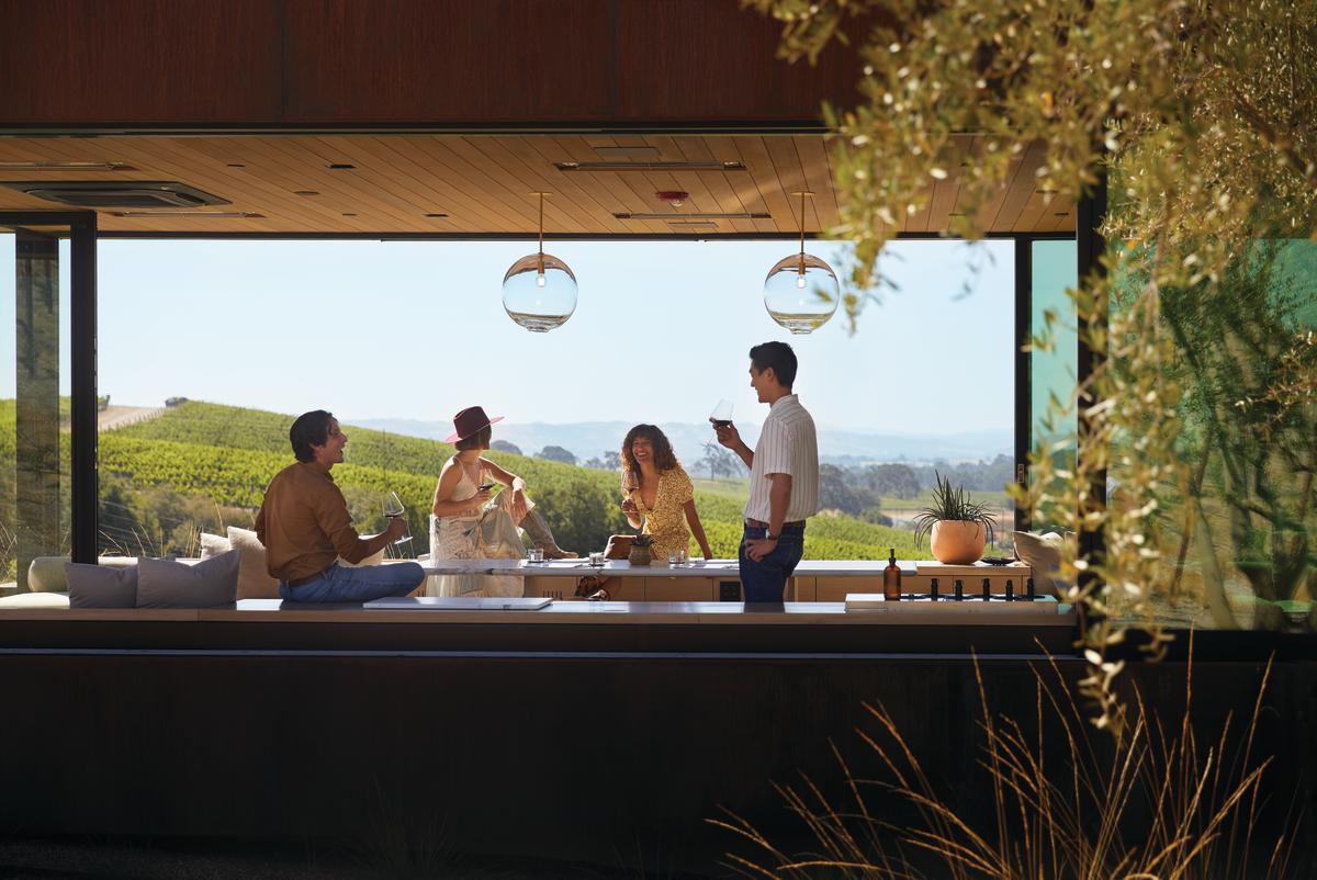 Friends drinking wine in the window