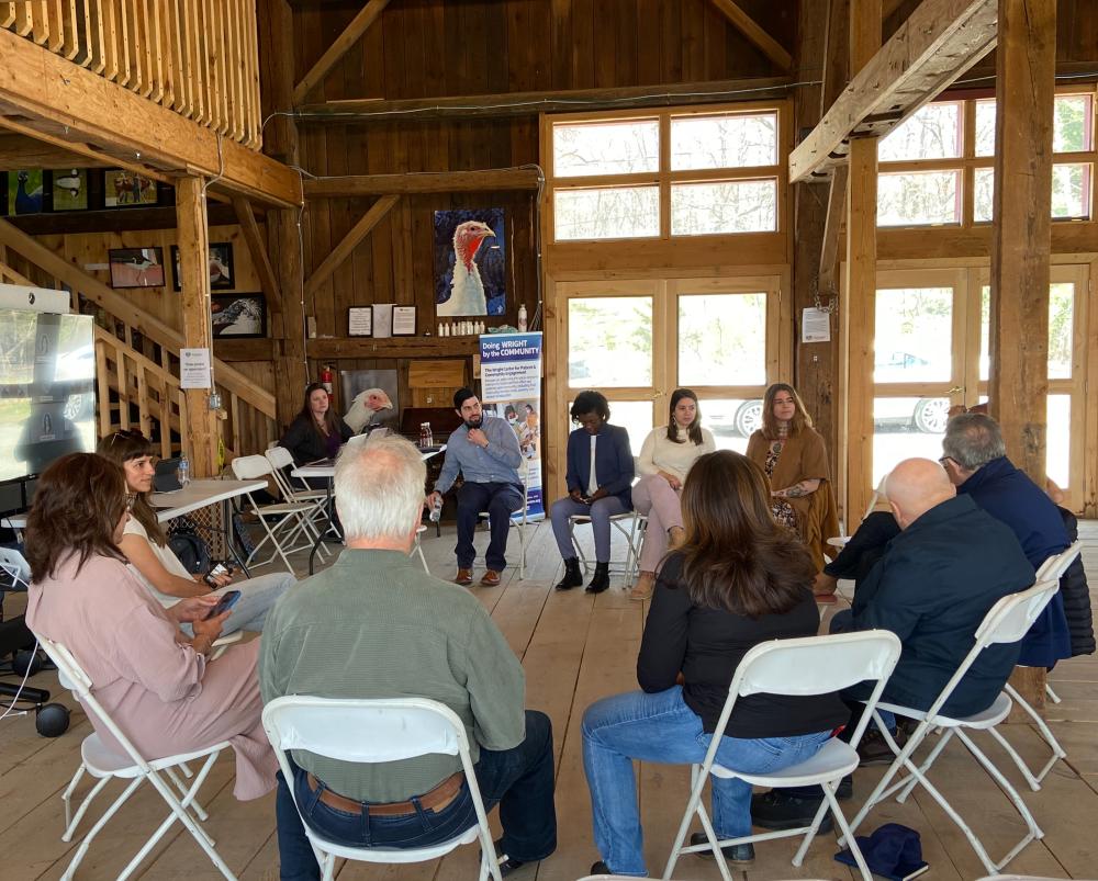 A group of people meeting at the Art Barn at Indraloka Animal Sanctuary